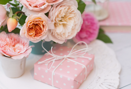 Fibromyalgia Gifts: a pink wrapped gift and a flower bouquet