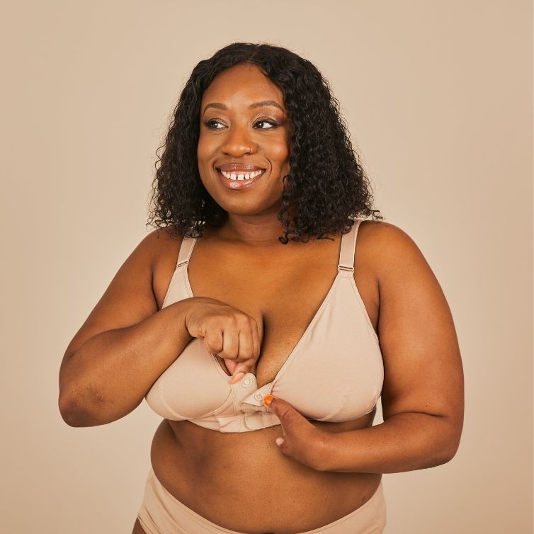 Beautiful black model smiling widely looking away from the camera while wearing the Springrose bras for elderly with dementia in beige