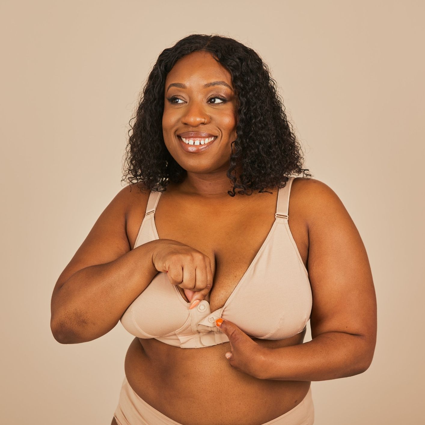 Beautiful model with a limb difference showcasing the Springrose adaptive magnetic bra in beige