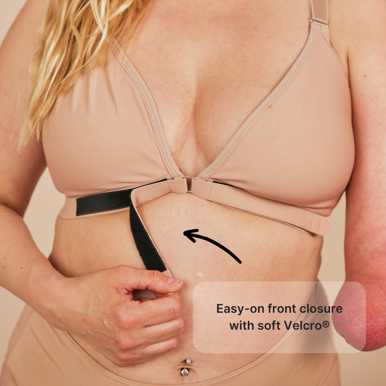 Close up of the Velcro front closure in the Springrose easy on one handed bra. The model has one hand. Text reads: easy-on front closure with soft Velcro.