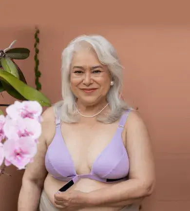 Beautiful woman putting on the adaptive bra in terracotta in multiple ways, including with one hand, by stepping into it, and by pulling it on overhead