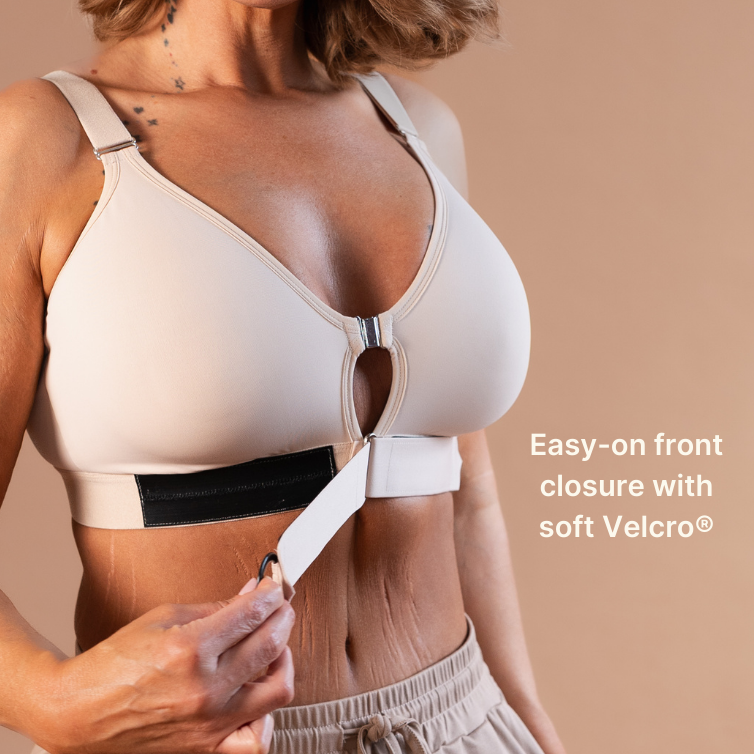 Beautiful mature model showing the velcro closure of the supportive adaptive bra in almond