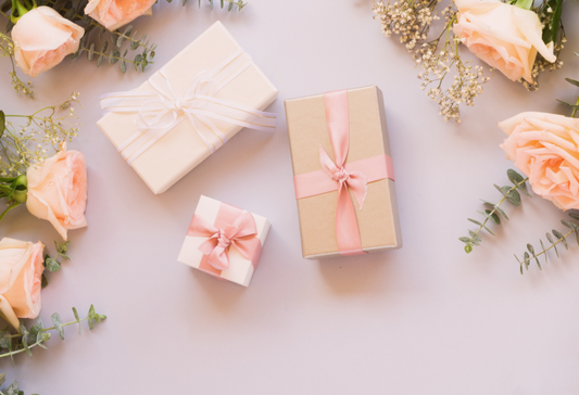 Best Gifts for Ehlers Danlos Syndrome (EDS) - three gift boxes with pink roses around them