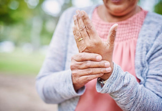 arthritis bra - woman holding her hand