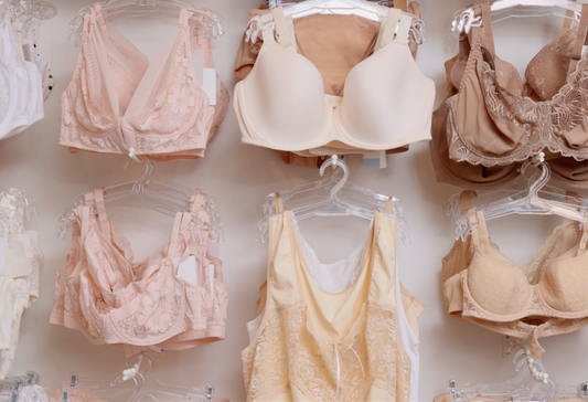 Most comfortable bra: a series of neutral colored bras hanging from a wall