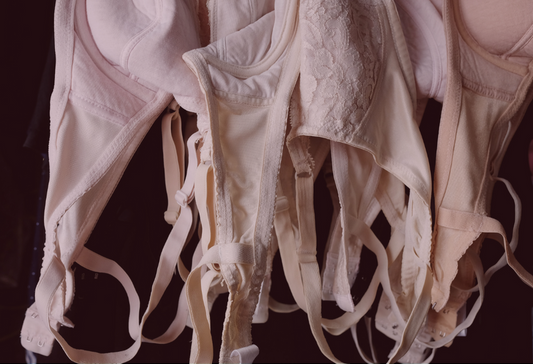 What to do with old bras: used, light colored bras hanging