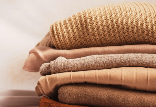Clothes for stroke patients: a pile of neutral colored knit clothing