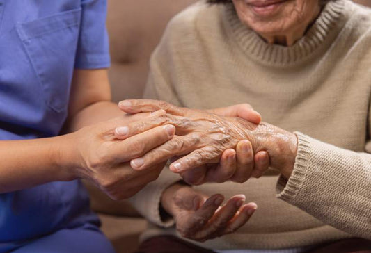Gifts For Rheumatoid Arthritis: a close up of a younger woman massaging an older woman's hands