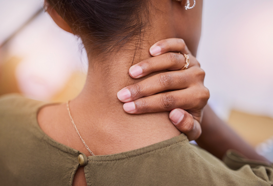Nerve pain tips: woman rubbing her neck from pain