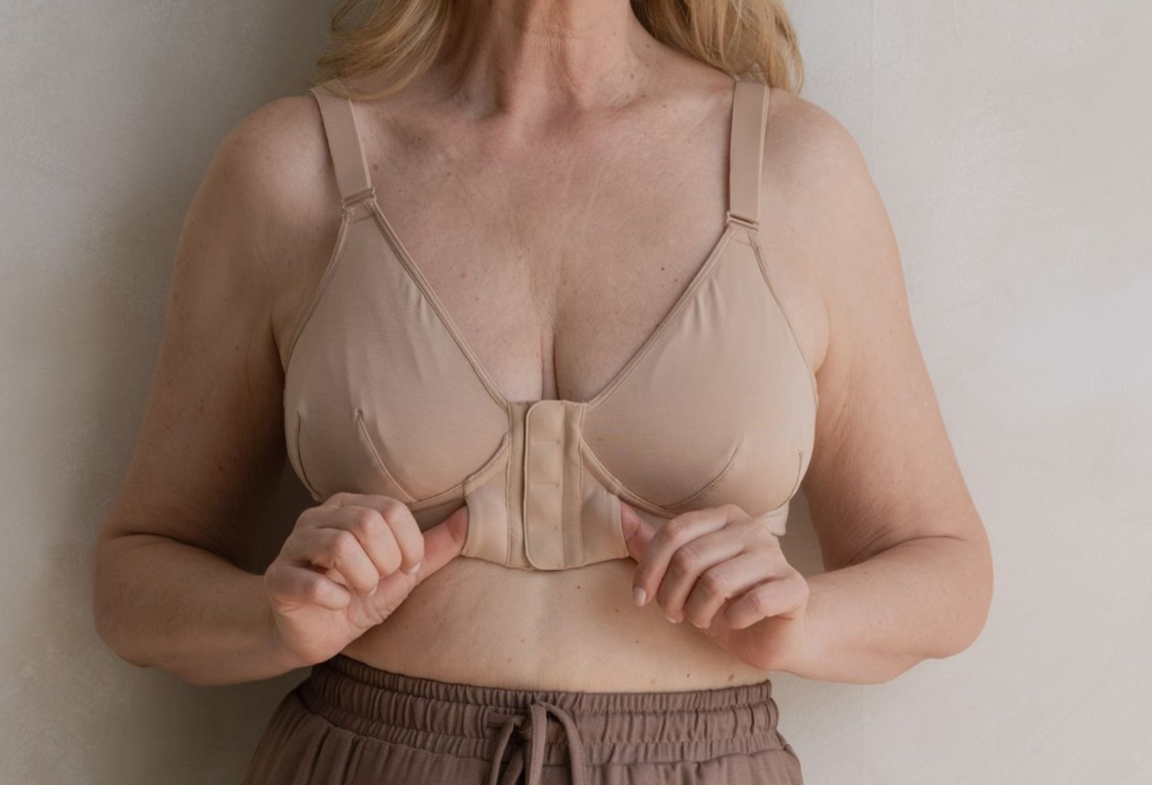 Best bra for older women, a magnetic front closing bra in beige with finger pockets