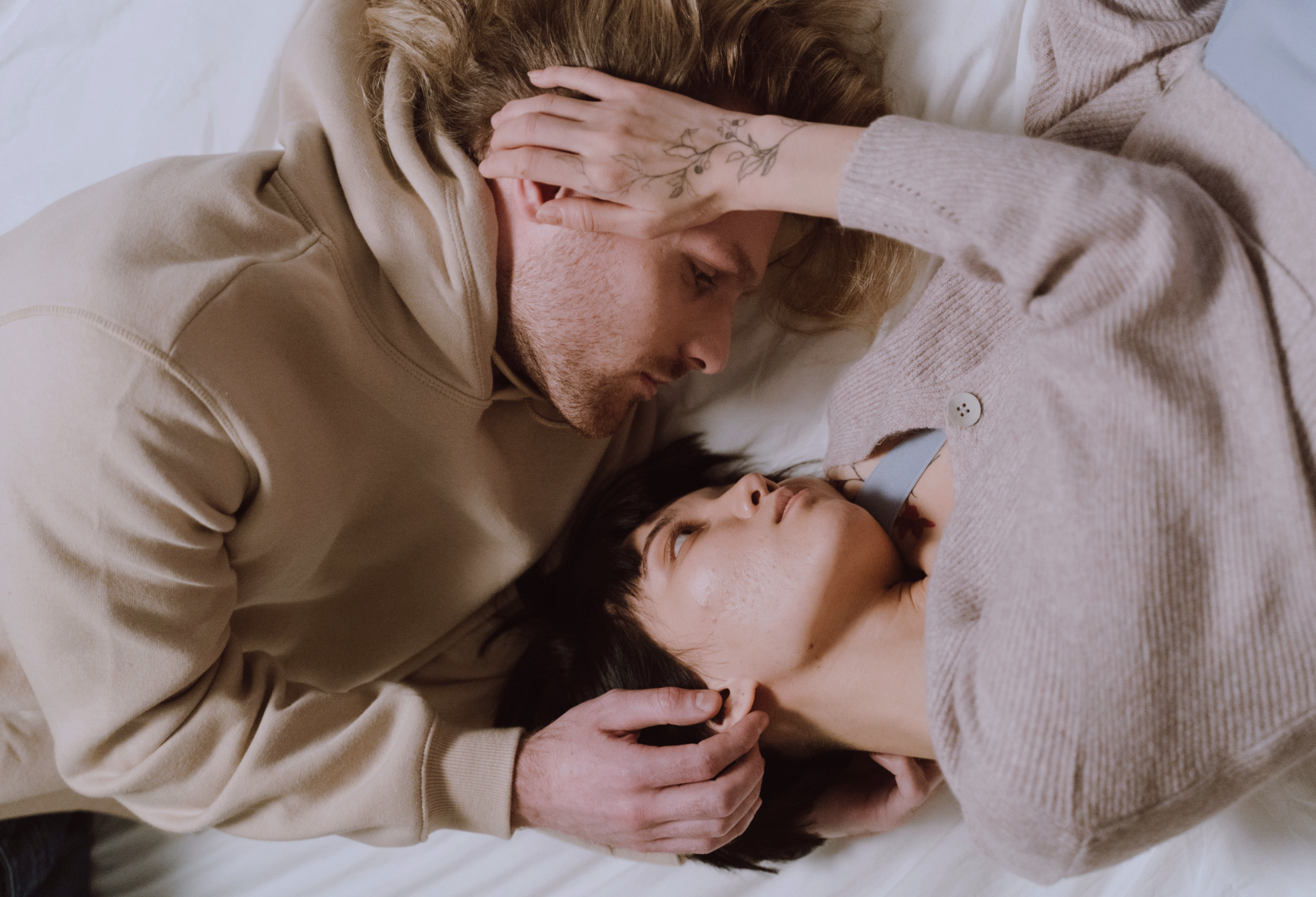 How Does Lupus Affect Relationships: Couple living with lupus embracing while lying in bed