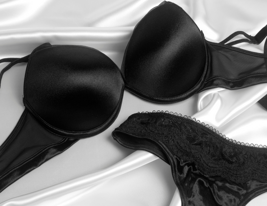 How often should I replace my bras: black bra and underwear on satin white sheets