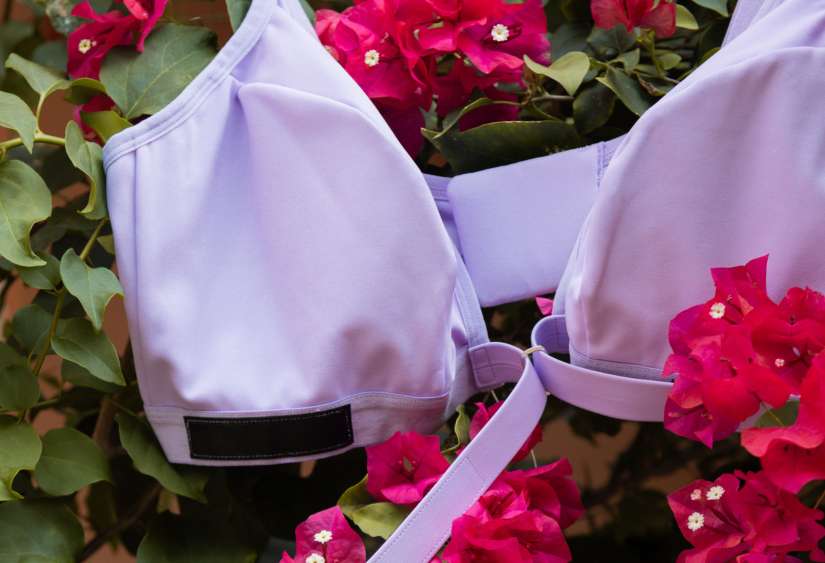 velcro bra: the Springrose adaptive velcro bra in lilac laying on beautiful flowers