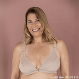 Model is wearing the best front closing bra for seniors in beige - an adaptive bra with a velcro front closure