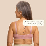 Beautiful silver haired model from the back, showing the back closure on the easy on bra for seniors in pink