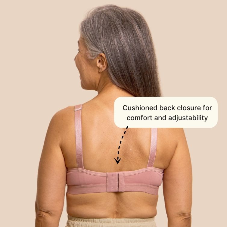 Beautiful silver haired model from the back, showing the back closure on the easy on bra for seniors in pink