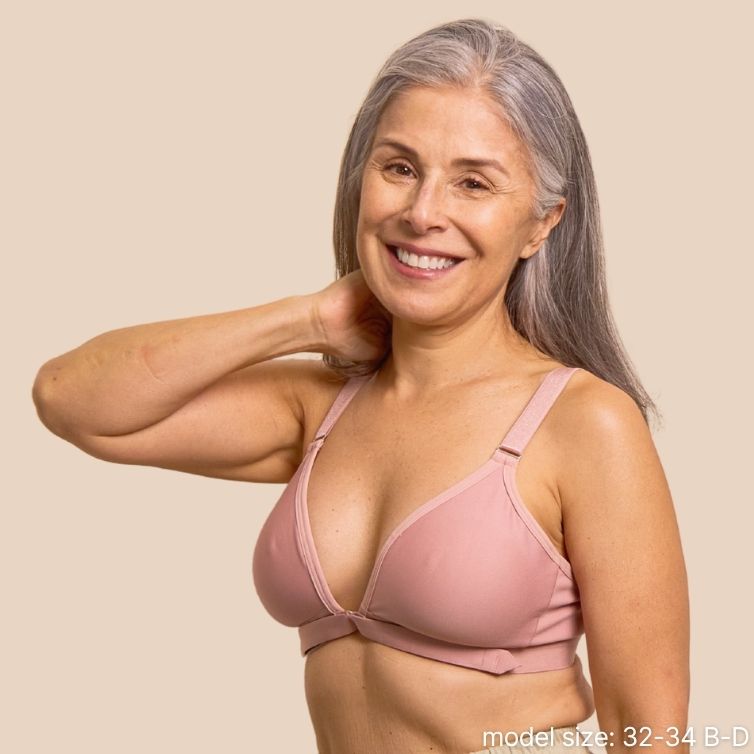 Beautiful silver haired model showcasing the adaptive bra for seniors with Velcro front closure in pink