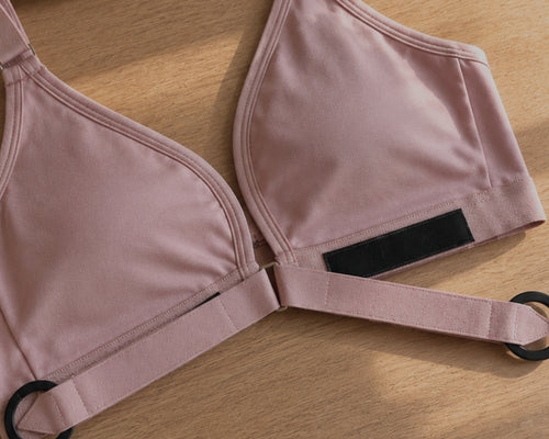Close up of Springrose's adaptive velcro front close bra in pink. A flatlay of the bra with the velcro closure open
