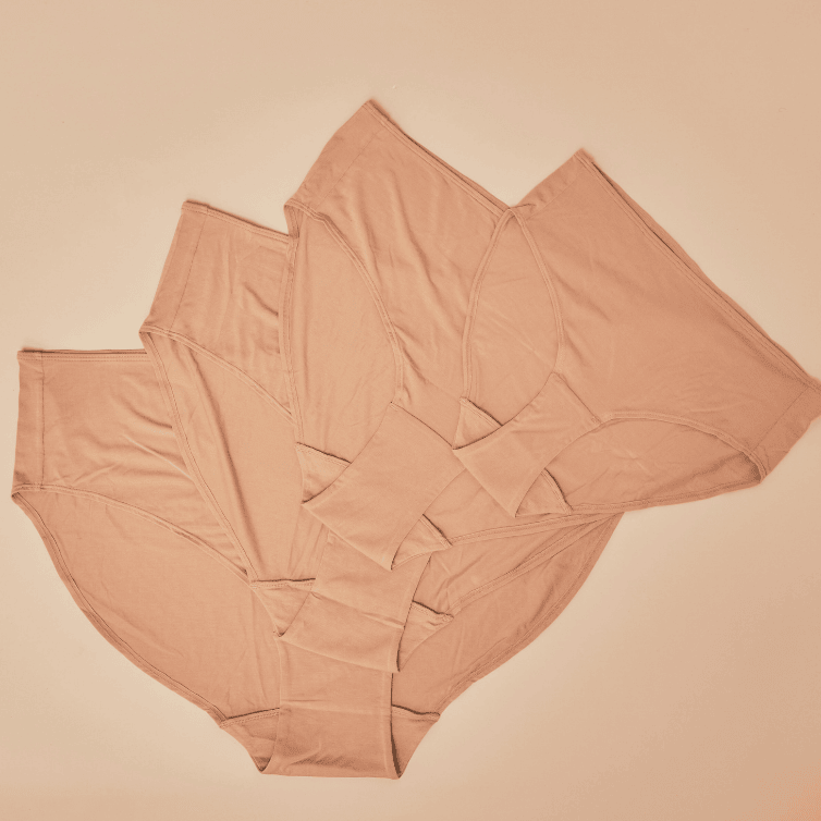 Flat lay of the modal high waisted underwear in beige. Four sizes are visible.