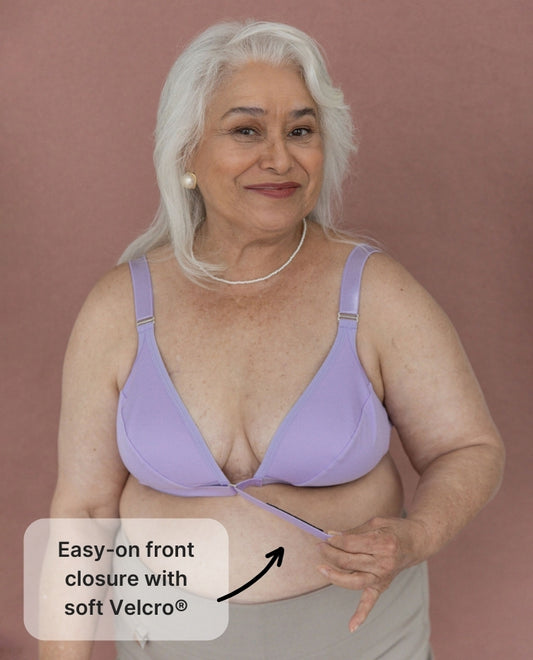 Beautiful, silver-haired model showing the Springrose velcro bra's velcro front closure