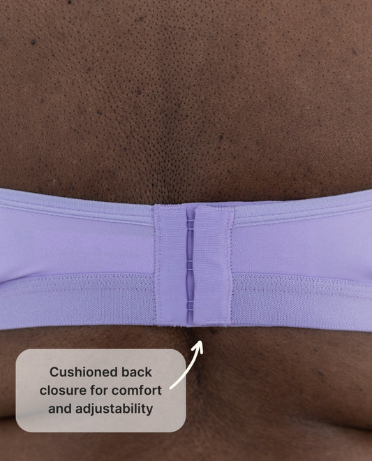 Back closure for the Springrose adaptive bra in lilac. Text reads: cushioned back closure for comfort and adjustability.