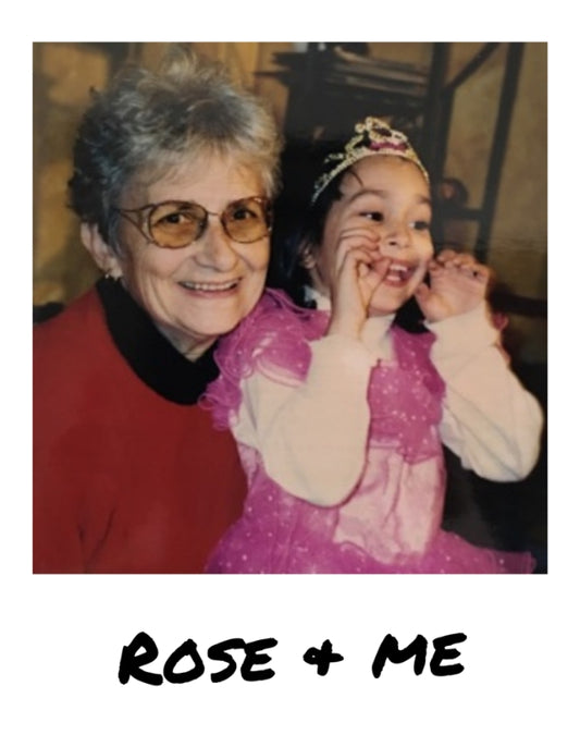 Grandmother Rose smiling big into the camera and Nicole as a child, sitting on her grandmother's lap, smiling and gesturing with her hands