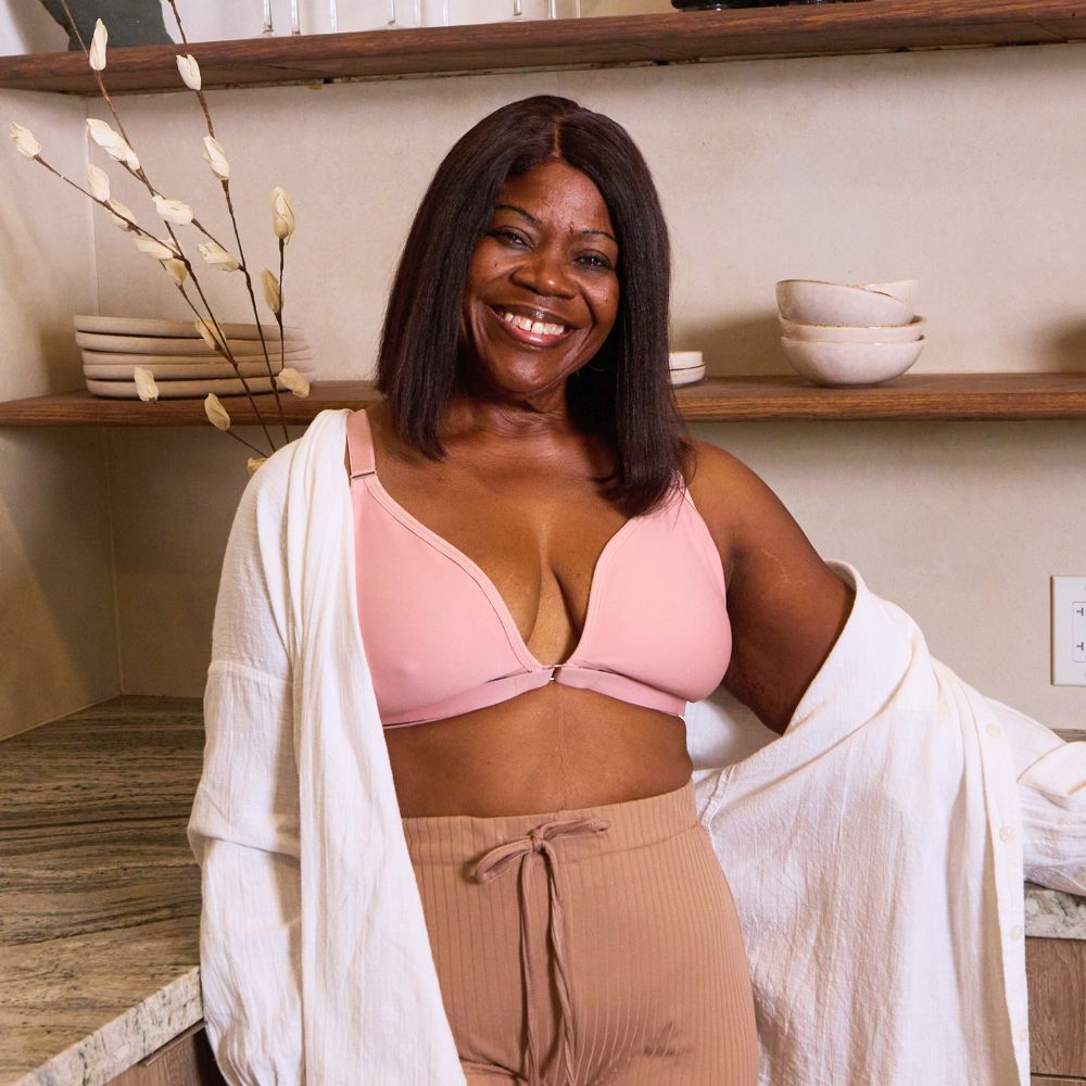 Beautiful mature model wearing a pink velcro bra while hanging out in a kitchen