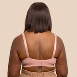 Back shot of a model wearing the Springrose Velcro bra in pink