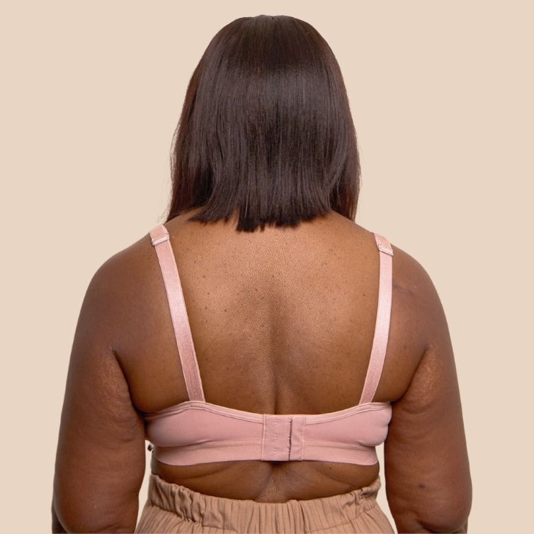 Back shot of a beautiful black model wearing the Springrose Velcro bra in pink