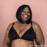 Model is wearing the best front closing bra for seniors in black - an adaptive bra with a velcro front closure