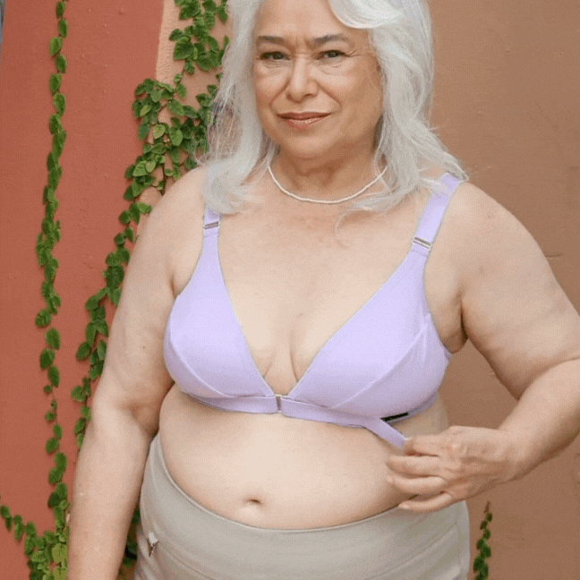 Mature woman opening and closing the Springrose adaptive bra in lilac
